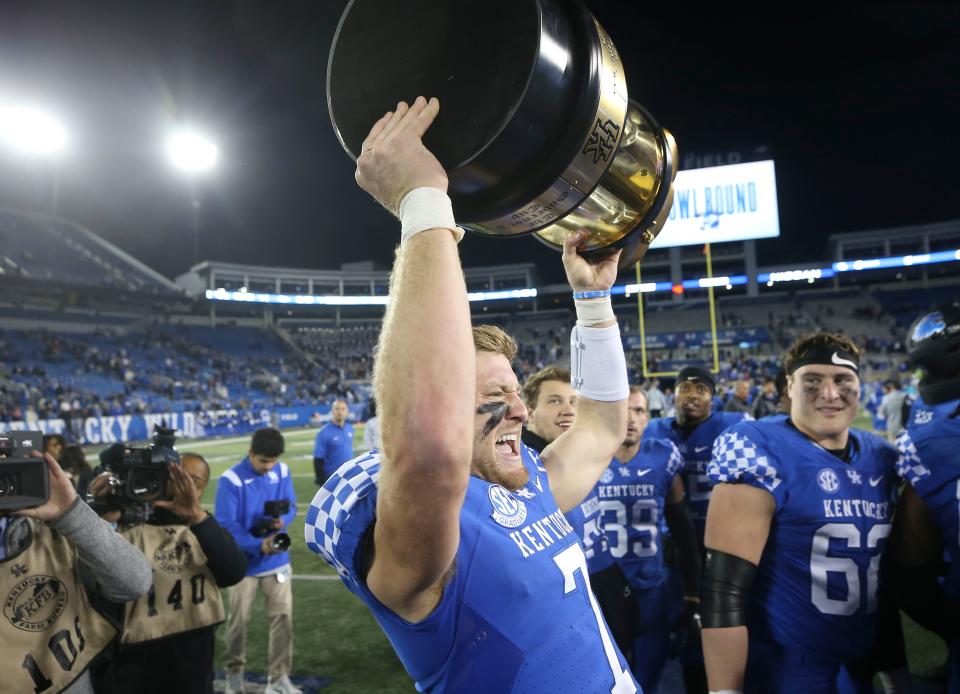 Kentucky quarterback Will Levis celebrates with the Governors Cup trophy after the Wildcats beat visiting Louisville in Saturday's Battle of the Bluegrass college football game. Nov. 26, 2022.  