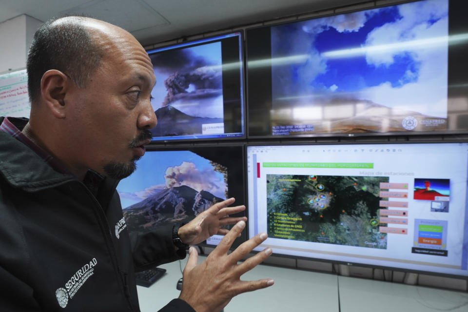 FILE - Paulino Alonso Rivera, who works at the National Center for Disaster Prevention of Mexico, gives an interview as he monitors the Popocatépetl volcano, in Mexico City, Feb. 8, 2023. Every time Mexico’s Popocatepetl volcano rumbles to life and belches out towering clouds of ash, there are dozens of scientists, a network of sensors and cameras and a roomful of powerful equipment watching its every move. (AP Photo/Marco Ugarte, File)