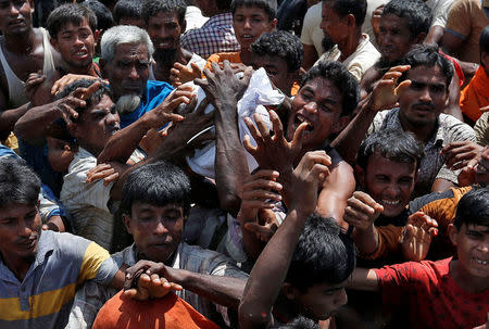 Rohingya refugees react as aid is distributed in Cox's Bazar, Bangladesh, September 21, 2017. REUTERS/Cathal McNaughton