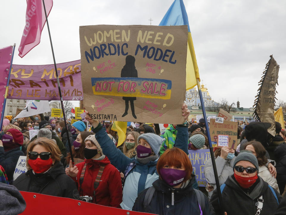 Women shouts slogans at a rally on the occasion of the International Women's Day in Kyiv, Ukraine, Monday, March 8, 2021. Millions across the globe are marking International Women's Day by demanding a gender-balanced world amid persistent salary gap, violence and widespread inequality. (AP Photo/Efrem Lukatsky)