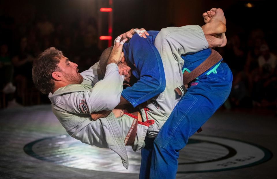 Lear Kirkland, left, grapples with Zach Mabey, a brown belt in Brazilian jujitsu, during their match at the Grapple in the Temple jujitsu tournament inside the Masonic Temple in Detroit on Friday, Aug. 11, 2023.