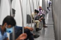 Commuters sit in a carriage of a Yellow Line train after Delhi Metro Rail Corporation (DMRC) resumed services following its closure due to the coronavirus pandemic in New Delhi on September 7, 2020. (Photo by PRAKASH SINGH/AFP via Getty Images)