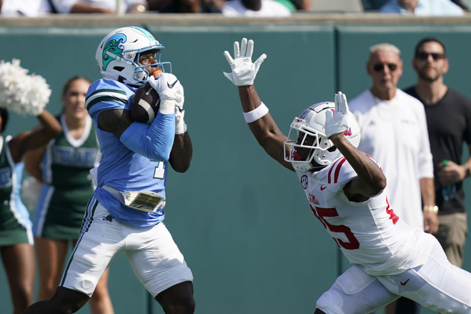 Tulane wide receiver Jha'Quan Jackson (4) pulls in a touchdown reception against Mississippi safety Trey Washington in the first half of an NCAA college football game in New Orleans, Saturday, Sept. 9, 2023. (AP Photo/Gerald Herbert)