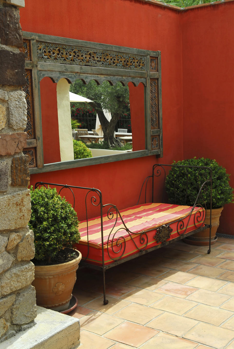 <div class="caption-credit"> Photo by: iStockphoto</div>Bring the outside in: A fusion of old Spanish with Tuscan style is seen here with its flower pots, colored walls and Mediterranean accessories. Outdoor living rooms are typical of a Spanish decorative ambiance. <br>