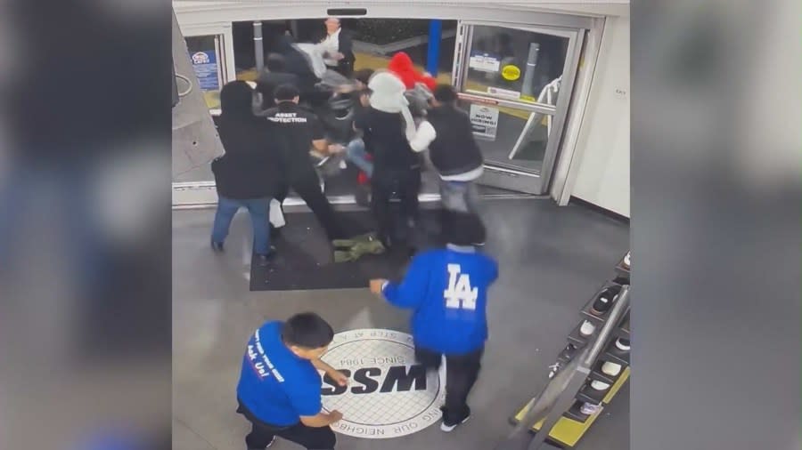 Store employees and security guards struggling to stop the violent flash robbery crew from ransacking a WSS shoe store in Los Angeles. (Los Angeles Police Department)