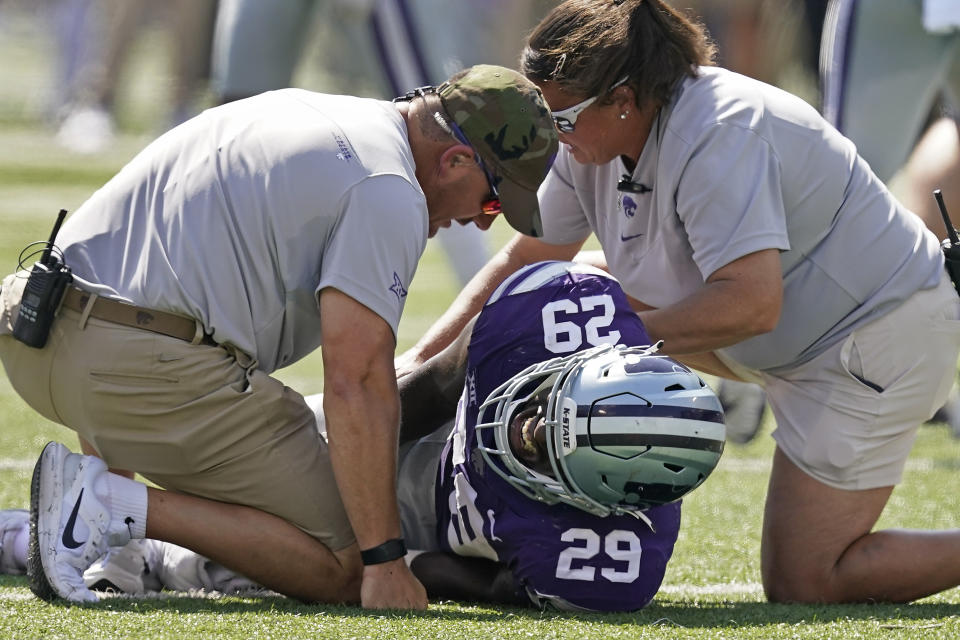 Kansas State defensive end Khalid Duke (29) is helped after being injured during the first half of the team's NCAA college football game against Nevada on Saturday, Sept. 18, 2021, in Manhattan, Kan. (AP Photo/Charlie Riedel)