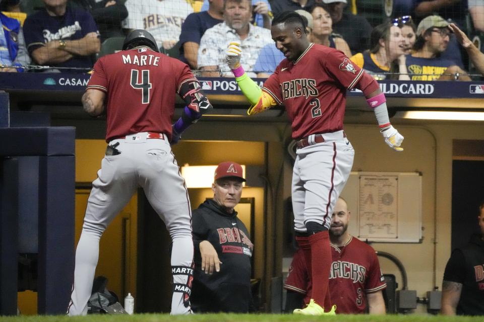 Arizona Diamondbacks' Ketel Marte celebrates his home run with Geraldo Perdomo (2) during the third inning of a Game 1 of their National League wildcard baseball game against the Milwaukee Brewers Tuesday, Oct. 3, 2023, in Milwaukee. (AP Photo/Morry Gash)