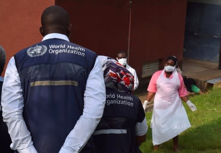 World Health Organization (WHO) officials talk to Ugandan medical staff as they inspect ebola preparedness facilities at the Bwera general hospital near the border with the Democratic Republic of Congo in Bwera