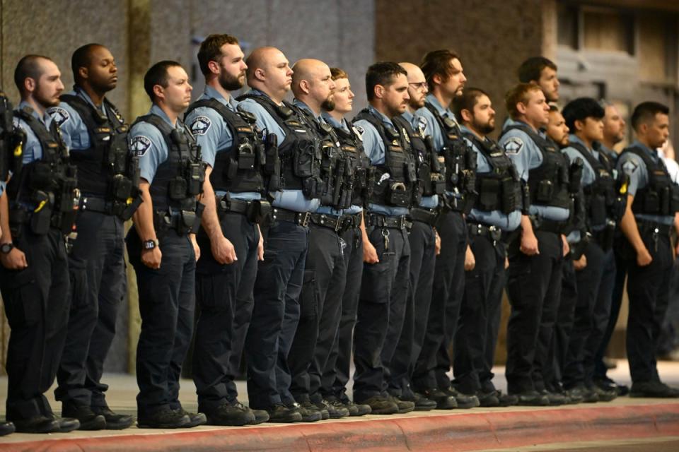 Members of law enforcement gather outside Hennepin County Medical Center in Minneapolis (AP)