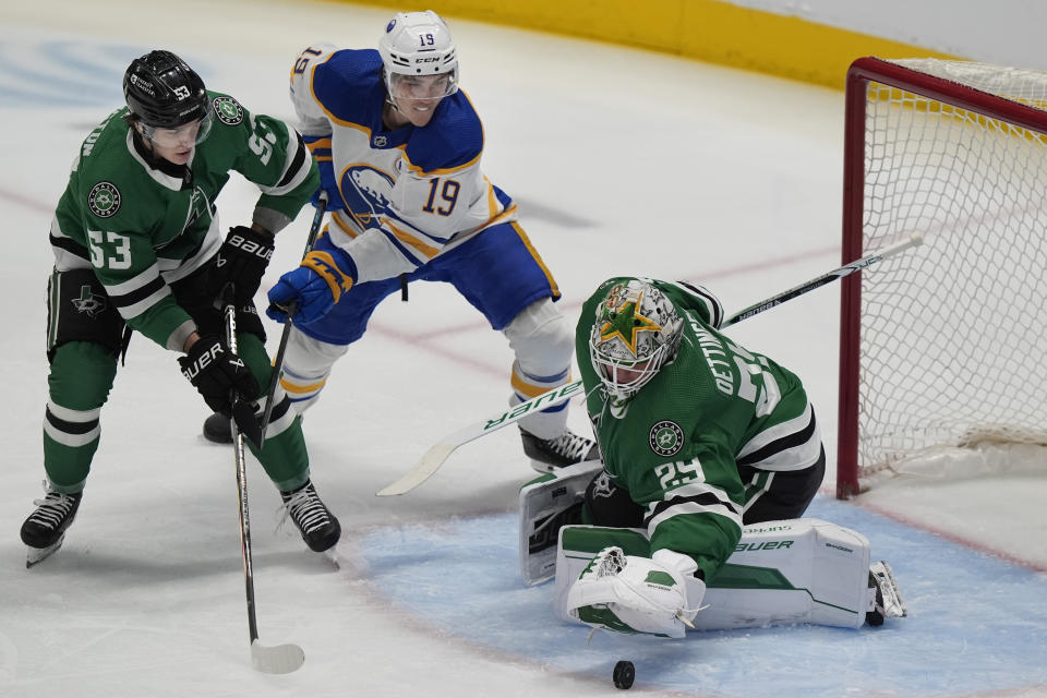 Dallas Stars goaltender Jake Oettinger (29) and center Wyatt Johnston (53) defend the goal against Buffalo Sabres center Peyton Krebs (19) during the first period of an NHL hockey game in Dallas, Tuesday, April 9, 2024. (AP Photo/LM Otero)