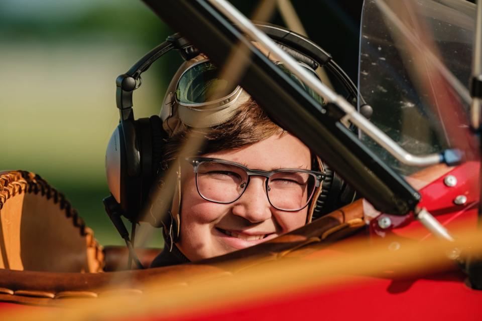 Cooper Winters, 12, taxis in the Hatz biplane owned and operated by flight instructor Ryan Newell at New Philadelphia's Harry Clever Field on Saturday. Winters was among 14 middle school students who completed the nine-week Wright Flight class offered by Chapter 1077 of the Experimental Aircraft Association.