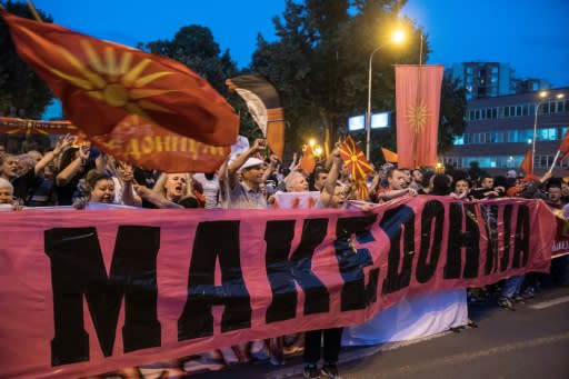 Protestors wave flags outside parliament in Skopje on June 13 against the proposed new name for the country. Greece's main opposition party is also opposed to the 'North Macedonia' name deal to end a nearly three-decade row between the neighbours