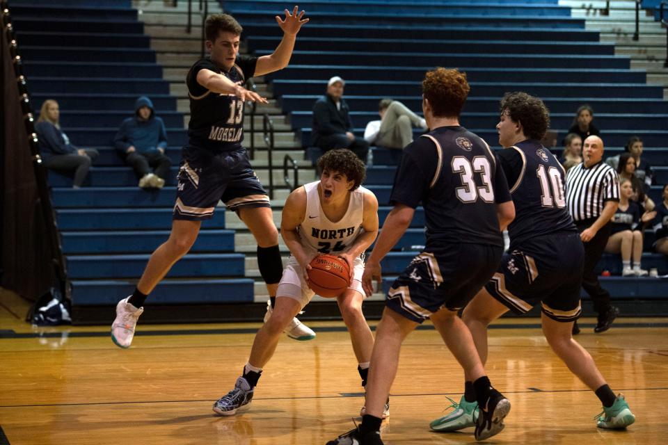 Council Rock North senior Adam Mahtat pump-fakes before going up for a shot against Lower Moreland.