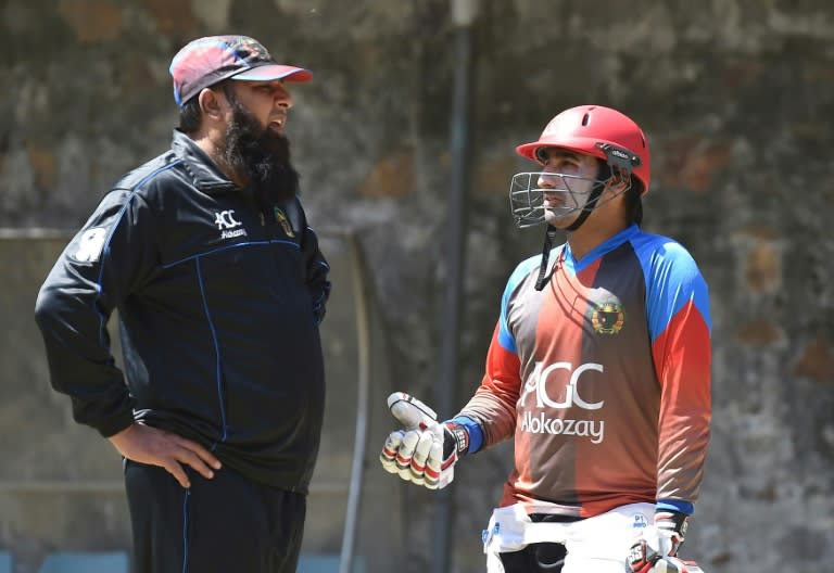 Afghanistan cricket coach Inzamam-ul-Haq (L) talks with captain Asghar Stanikzai during a training session at Feroz Shah Kotla cricket ground in New Delhi on March 22, 2016