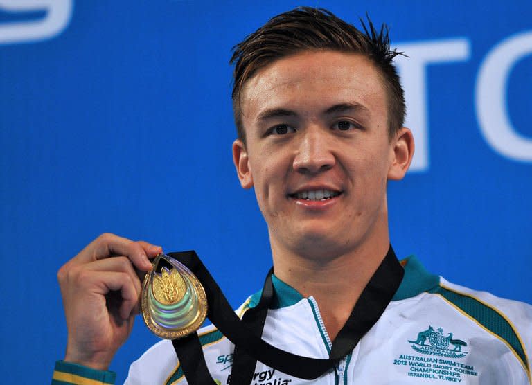 Robert Hurley of Australia smiles on the podium after winning the men's 50m backstroke final during the FINA World Short Course Swimming Championships in Istanbul