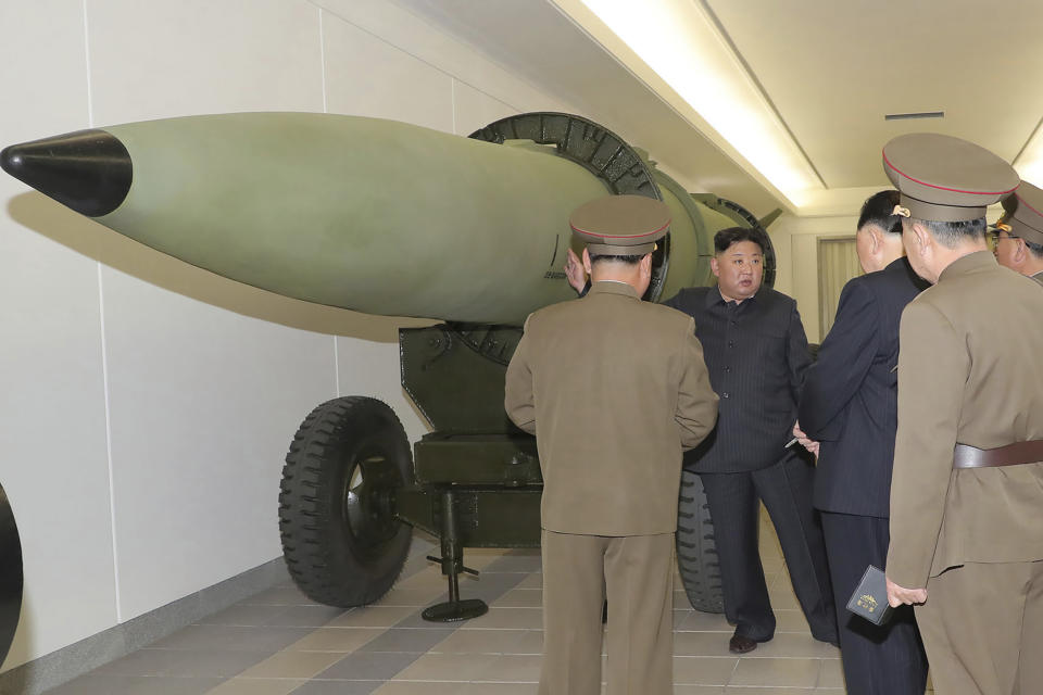 This photo provided on Tuesday, March 28, 2023, by the North Korean government, North Korean leader Kim Jong Un, rear, talks with military officials at a hall displayed what appeared to be various types of warheads designed to be mounted on missiles or rocket launchers on March 27, 2023, in undisclosed location, North Korea. Independent journalists were not given access to cover the event depicted in this image distributed by the North Korean government. The content of this image is as provided and cannot be independently verified. (Korean Central News Agency/Korea News Service via AP)