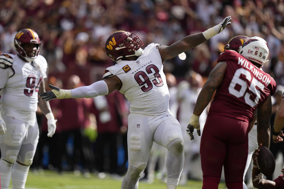 Washington Commanders defensive tackle Jonathan Allen (93) celebrates a sac as teammate defensive tackle Daron Payne (94) looks on at left, and Arizona Cardinals offensive tackle Elijah Wilkinson (65) is right, during the second half of an NFL preseason football game, Sunday, Sept. 10, 2023, in Landover, Md. Washington won 20-16.(AP Photo/Alex Brandon)