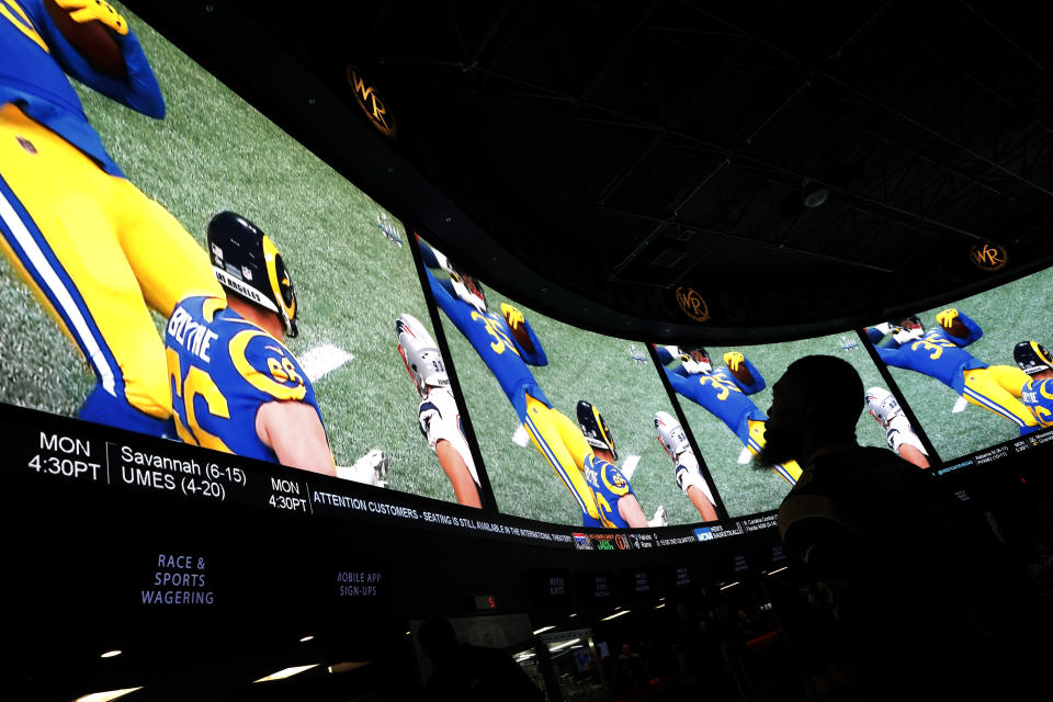 A man watches Super Bowl LIII at the Westgate Superbook sports book, Sunday, Feb. 3, 2019, in Las Vegas. (AP Photo/John Locher)