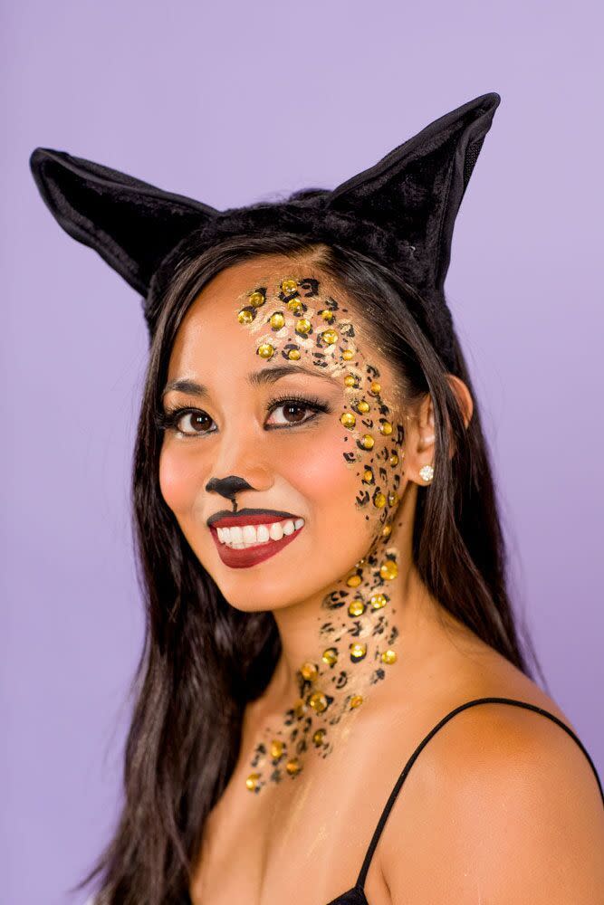 <p>Rhinestones in various sizes make this ferocious look sparkle and shine.</p><p><strong>Get the tutorial at <a href="https://www.goodhousekeeping.com/beauty/makeup/a22995483/cat-makeup/" rel="nofollow noopener" target="_blank" data-ylk="slk:Good Housekeeping;elm:context_link;itc:0;sec:content-canvas" class="link ">Good Housekeeping</a>.</strong> </p>