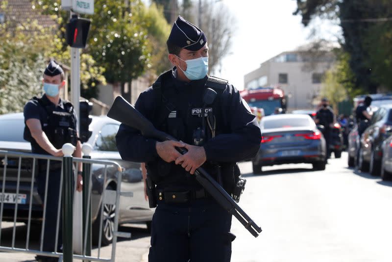 Police secure the area where an attacker stabbed a woman, in Rambouillet