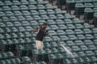 A worker cleans the stadium before baseball's Game 4 of the American League Division Series between the Chicago White Sox and the Houston Astros was postponed Monday, Oct. 11, 2021 in Chicago. (AP Photo/Charles Rex Arbogast)