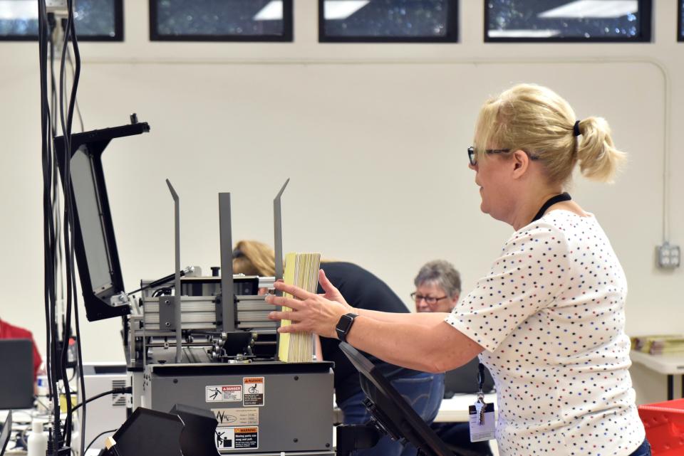 A Washington County elections worker sorts ballots before they're scanned by a signature verification machine inside the county's ballot counting center in St. George. 