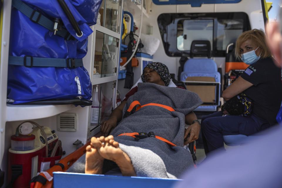 A migrant woman lays inside an ambulance after she has given birth, at Mytilene port, on the northeastern Aegean Sea island of Lesbos, Greece, Wednesday, June 22, 2022. Authorities in Greece say the woman from Eritrea has given birth on an uninhabited rocky islet after traveling from nearby Turkey with other migrants. A coast guard official said 30 adult Eritreans ‒ 25 men and five women ‒ were spotted during a patrol near Lesbos. (AP Photo/Panagiotis Balaskas)