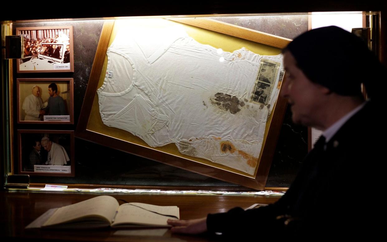 Sister Amelia from the Daughters of Charity stands in front of the altar where the bloodstained undershirt worn by Pope John Paul II during the assassination attempt on May, 13, 1981, in Rome - AP