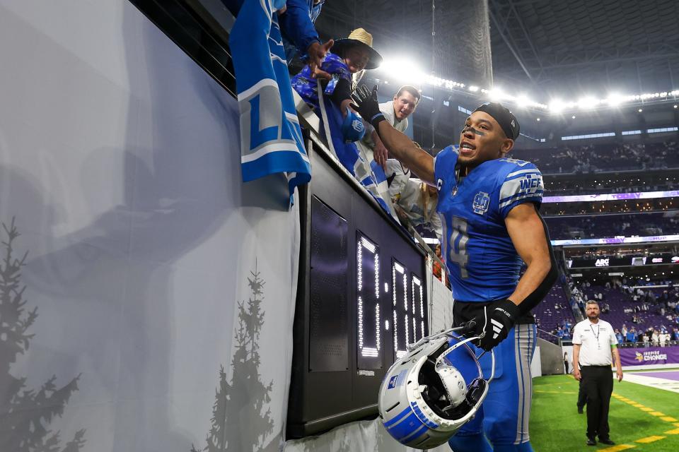 Lions wide receiver Amon-Ra St. Brown celebrates after the Lions' 30-24 win over the Vikings on Sunday, Dec. 24, 2023, in Minneapolis, to clinch the NFC North Division.