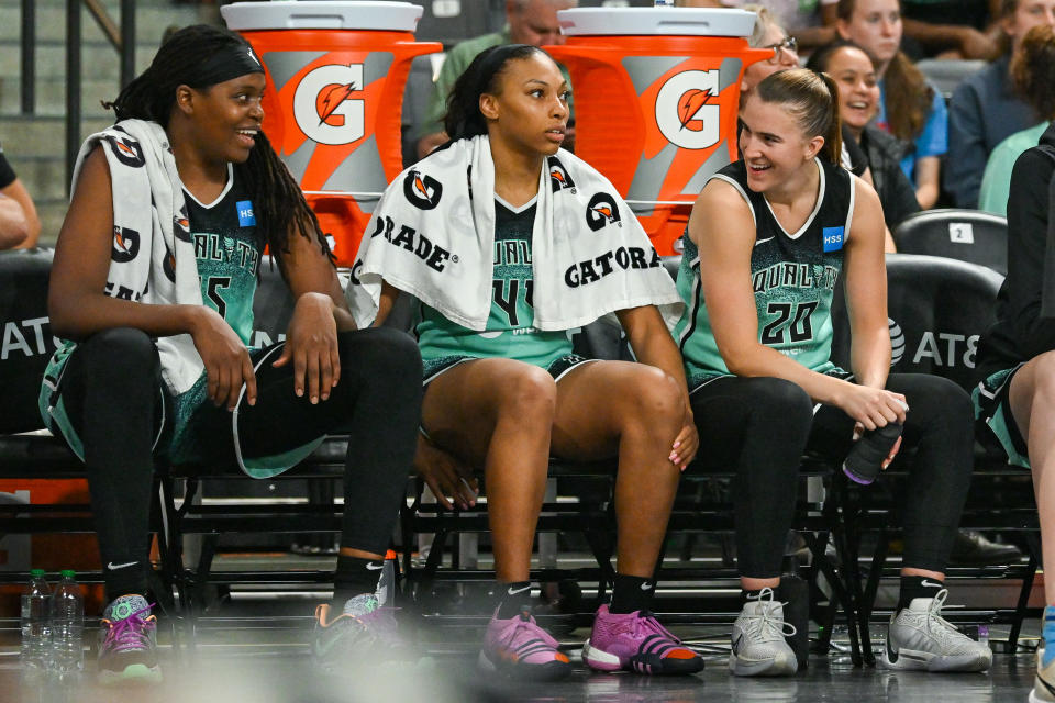 New York Liberty teammates Jonquel Jones, Betnijah Laney and Sabrina Ionescu share a moment on the bench during their game against the Atlanta Dream on June 23, 2023, at Gateway Center Arena in College Park, Georgia. (Rich von Biberstein/Icon Sportswire via Getty Images)