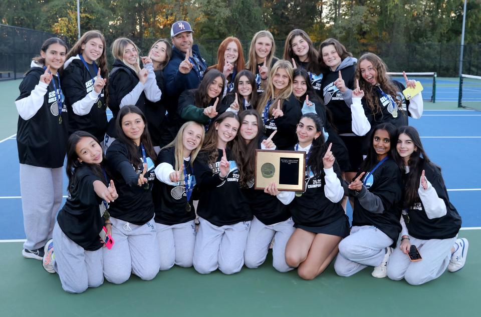 Byram Hills tennis players pose with the championship plaque after the Section One girls tennis team finals were held at Harrison High School, Oct. 18, 2022. Byram Hills beat Rye Neck in the Division Two Championship.