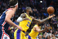 Los Angeles Lakers forward LeBron James, center, grabs a defensive rebound during the first half of the team's NBA basketball game against the Washington Wizards on Wednesday, April 3, 2024, in Washington. (AP Photo/John McDonnell)