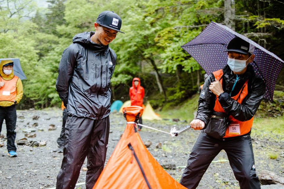 takashi doi looks on a trans japan ultra official tests his tent