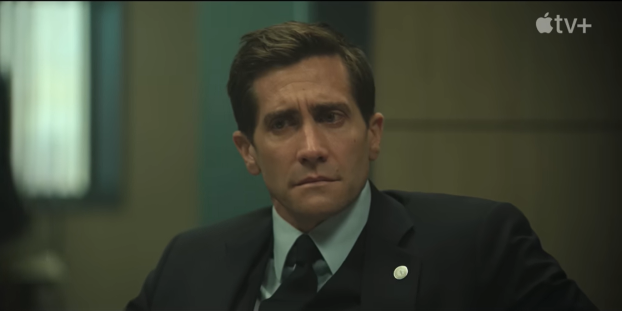 presumed innocent trailer, jake gyllenhaal looks worried while wearing a suit