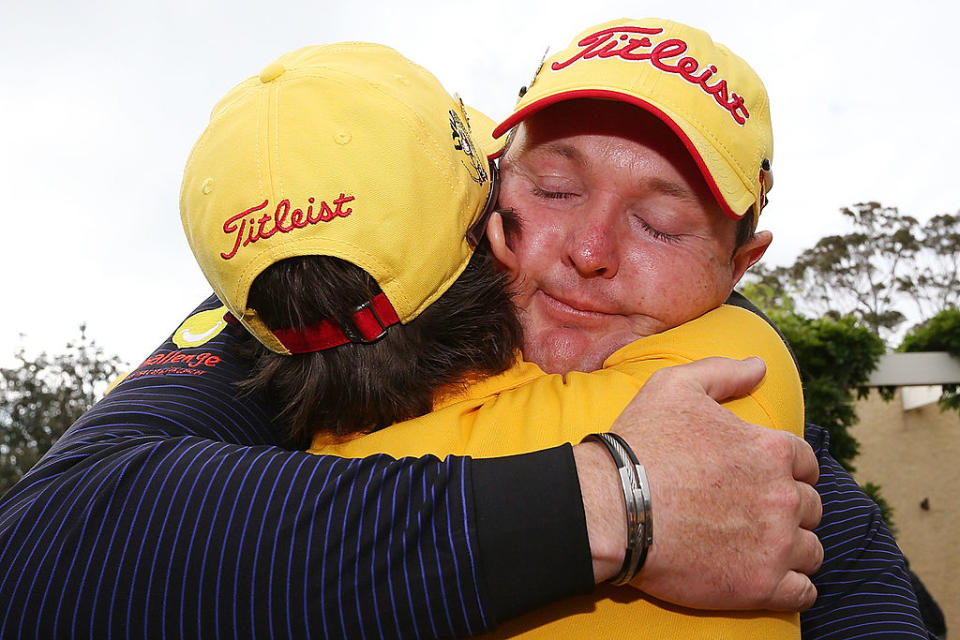 Jarrod Lyle of Australia hugs wife Briony Lyle after the 18th hole during round one of the 2013 Australian Masters at Royal Melbourne Golf Course on November 14, 2013 in Melbourne, Australia. (Photo by Michael Dodge/Getty Images)