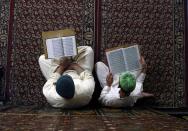 <p>Kashmiri Muslims read verses from the Quran, Islam’s holy book, inside the shrine of Shah-e-Hamdan during the holy month of Ramadan in Srinagar, Kashmir, May 29, 2017. (AP Photo/Mukhtar Khan) </p>