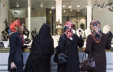Women look at jewellery displayed in the window of a shop in northern Tehran in this May 26, 2009 file photo. REUTERS/Stringer/Files