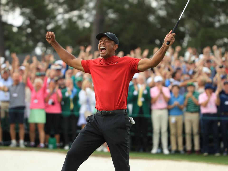 Tiger Woods (L) of the United States celebrates on the 18th green after winning the Masters at Augusta National Golf Club on April 14, 2019 in Augusta, Georgia