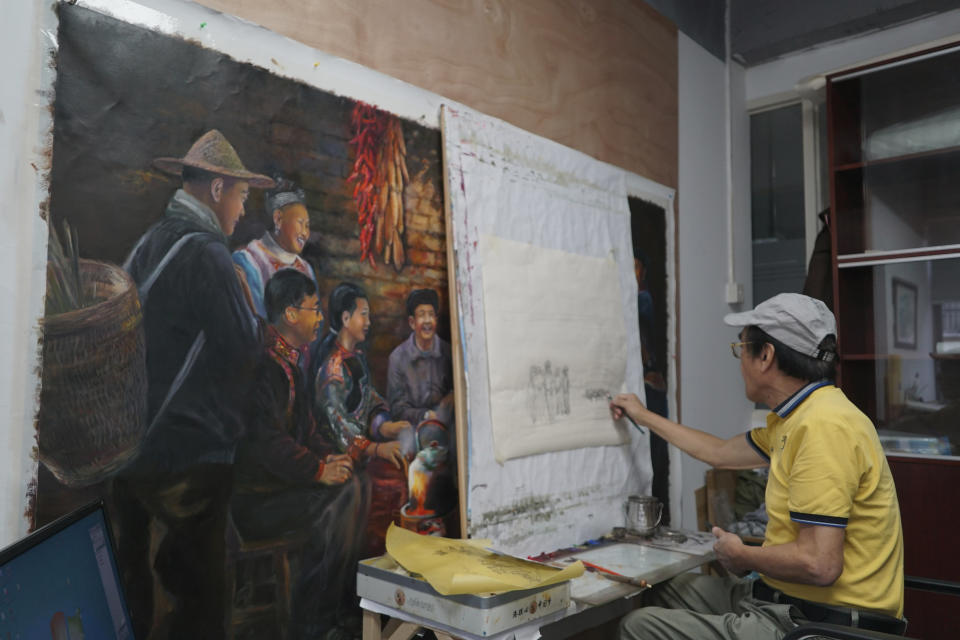 Zeng Fanzhi, a retired architect turned artist, paints at his studio in Shenzhen in southern China's Guangdong province, Tuesday, Oct. 24, 2023. Zeng painted stark, realist portrayals of life in China under zero-COVID, saying he did so to capture a unique moment in history. (AP Photo/Dake Kang)