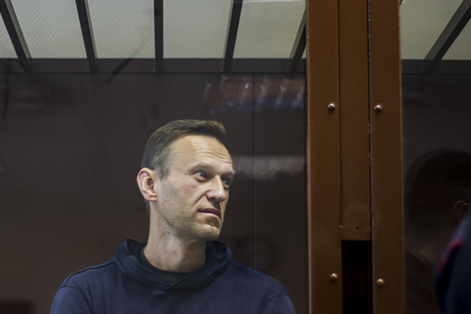 In this photo provided by the Babuskinsky District Court, Russian opposition leader Alexei Navalny stands in a cage during a hearing on his charges for defamation, in the Babuskinsky District Court in Moscow, Russia, Friday, Feb. 5, 2021. The European Union's top diplomat has told Russia's foreign minister that the treatment of Russian opposition leader Alexei Navalny represents "a low point" in the relations between Brussels and Moscow. EU foreign affairs chief Josep Borrell met with Russian Foreign Minister Sergey Lavrov in Moscow days after Navalny was ordered to serve nearly three years in prison. (Babuskinsky District Court Press Service via AP)