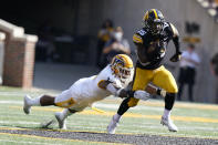 Iowa running back Tyler Goodson (15) runs from Kent State defensive lineman Jabbar Price (41) during the first half of an NCAA college football game, Saturday, Sept. 18, 2021, in Iowa City, Iowa. (AP Photo/Charlie Neibergall)