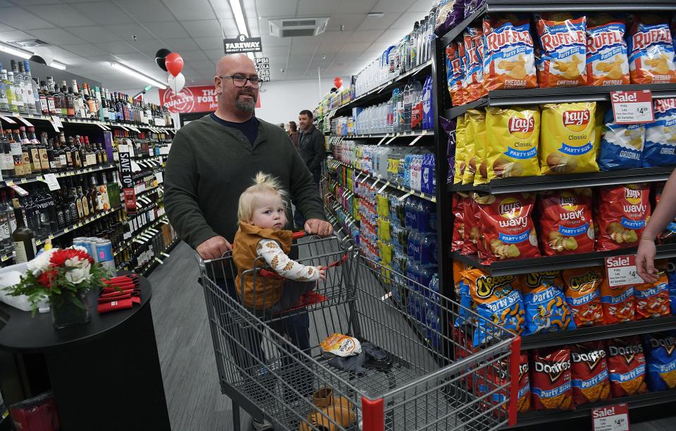 Mike Ahrens and Julia Lage, 1, look around the new Ogden Fareway store during the grand opening Tuesday. The store opened to customers on Wednesday.