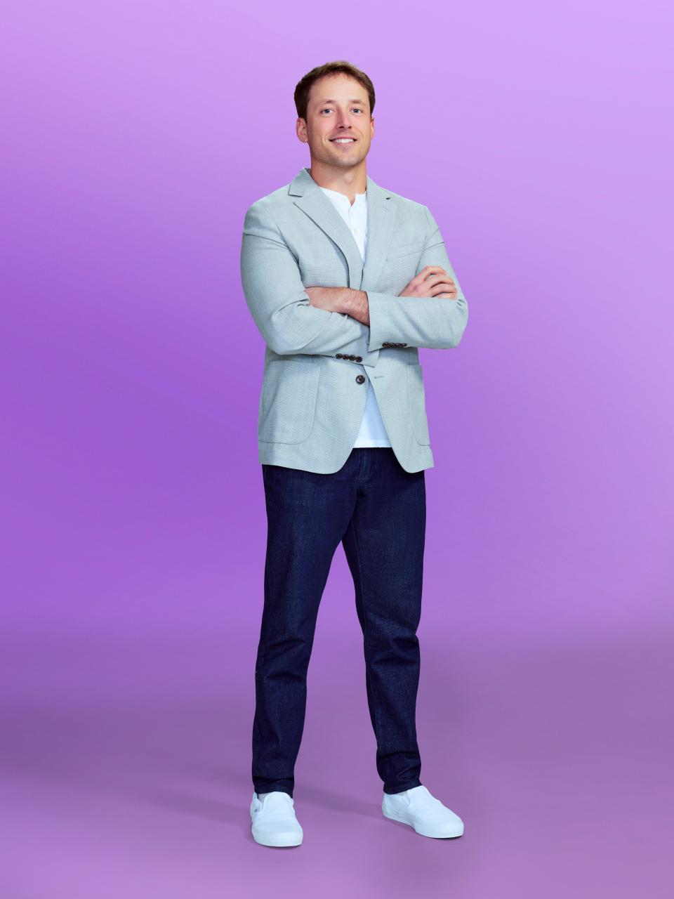 Jeramey, a candidate on "Love is blind" Season 6, wearing a grey jacket and blue pants