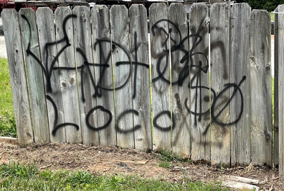 Graffiti on a fence along Fairforest Road at Lakeview Trailer Park Road.