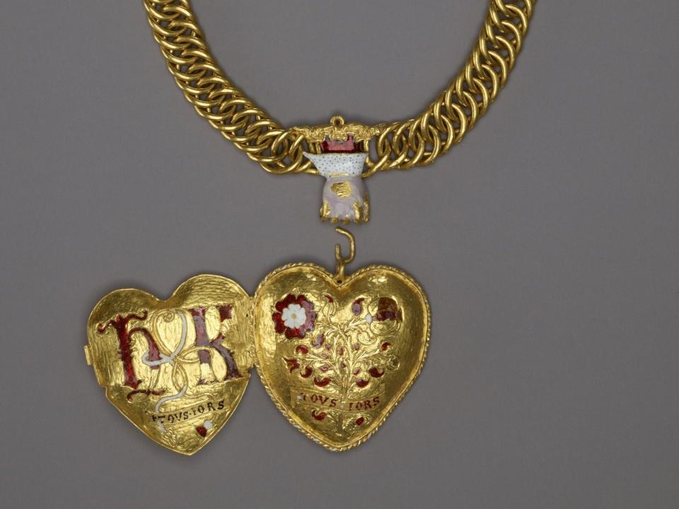 A picture shows the heart shaped locket, opened to reveal a compartment on the inside.