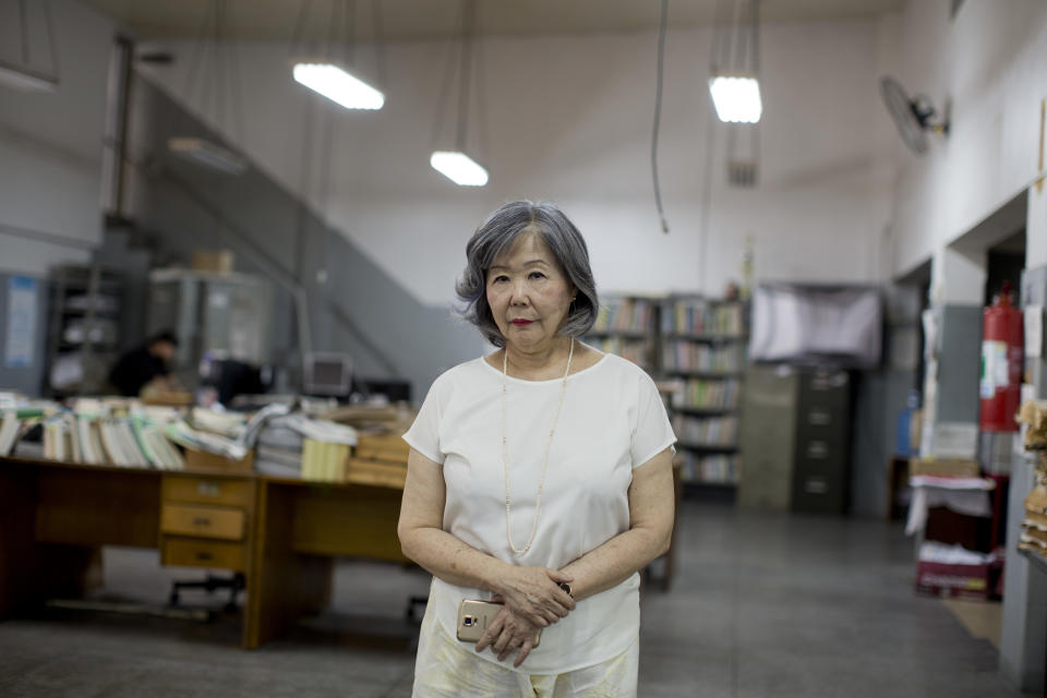 In this Dec. 26, 2018 photo, owner of the Sao Paulo Shimbun Japanese newspaper, Helena Mizumoto, poses for a portrait in her empty newsroom in Sao Paulo, Brazil, days before the final print edition on Jan. 1, 2019. Mizumoto said that before the internet and cable television, Japanese immigrants would call the newspaper to find out where they could find Japanese-owned business. "The Google of the community was here," Mizumoto said. (AP Photo/Victor R. Caivano)