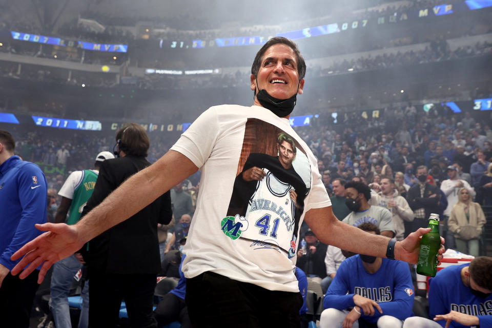 Dallas Mavericks team owner Mark Cuban wears a shirt honoring former player Dirk Nowitzki.