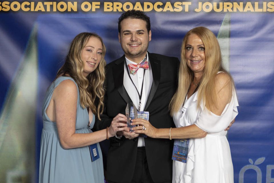 TV journalist Dylan Lyons, 24, poses for a photo with his girlfriend, left, and mom at the Florida Association of Broadcast Journalists awards ceremony on May 7, 2022 in Orlando, Fla. Lyons, a journalist with Spectrum 13 News in Orlando, was shot and killed Wednesday, Feb. 22, 2023, while covering a story about a murdered woman. (Jonathan Galed via AP)