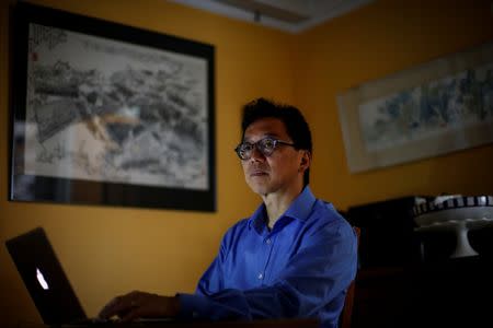 Charles Tien, a Professor of Political Science at Hunter College and the Graduate Center, CUNY, poses at his computer in his home in New York City, U.S., June 29, 2018. REUTERS/Brendan McDermid