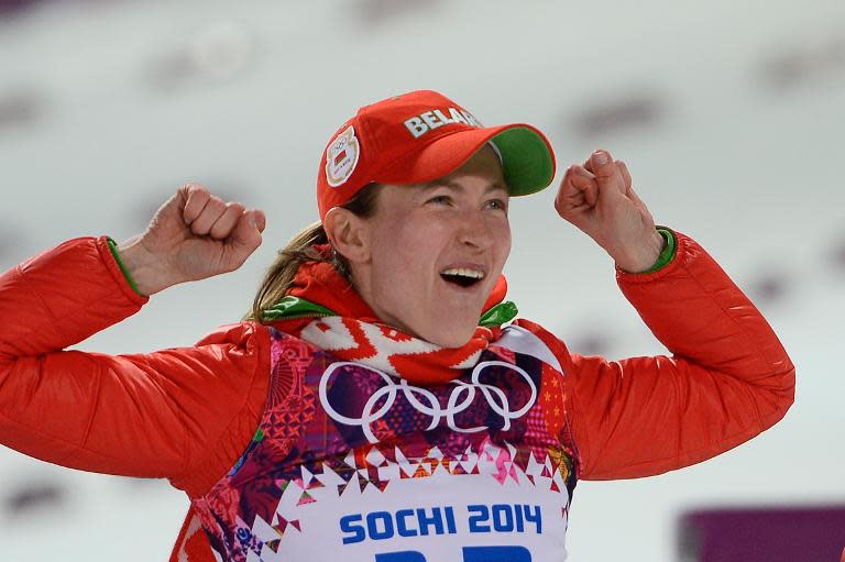 Gold medalist Belarus' Darya Domracheva celebrates on the podium during the Women's Biathlon 15 km Individual Flower Ceremony at the Laura Cross-Country Ski and Biathlon Center during the Sochi Winter Olympics on February 14, 2014 in Rosa Khutor